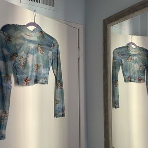 A mesh angel crop long sleeve shirt from Motel!